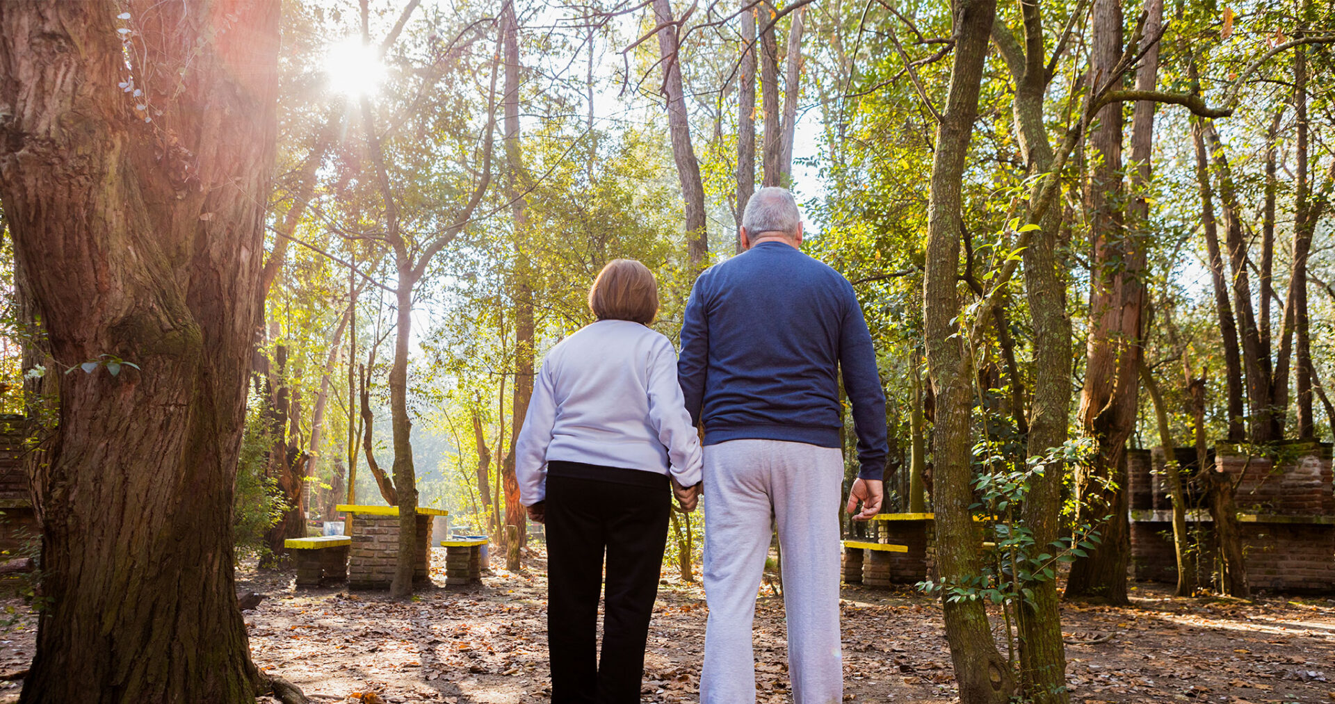 rear-view-retired-couple-walking-sunset.jpg
