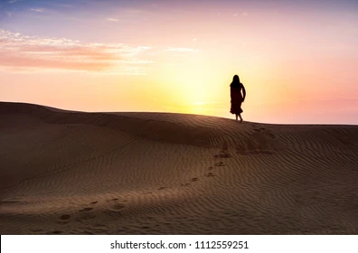 woman-walking-desert-sunset-view-260nw-1112559251.webp